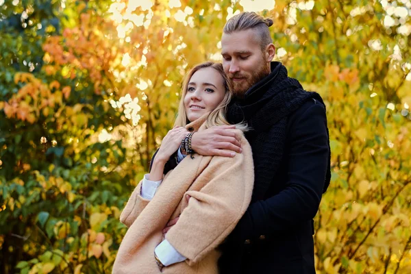 Attractive male hugs blonde female — Stock Photo, Image