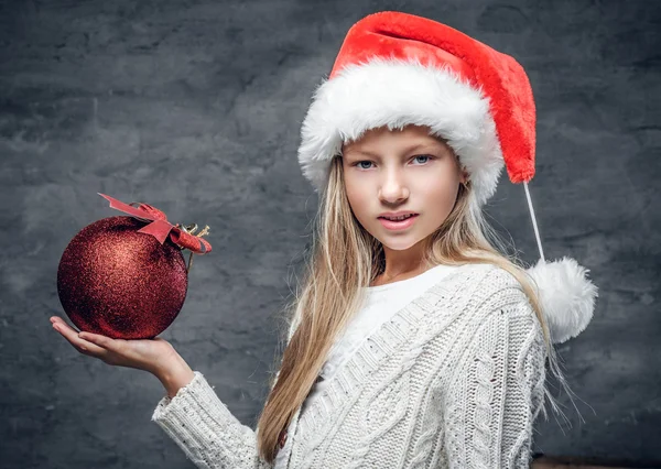 Girl holds red Christmas ball — Stockfoto