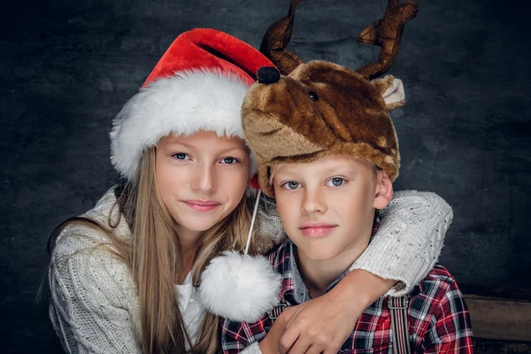 Девочка и милый мальчик в рождественских шляпах — стоковое фото
