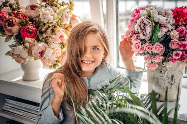 Blonde girl with the colorful flower bouquet.