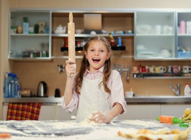 Positive little girl making dough clipart