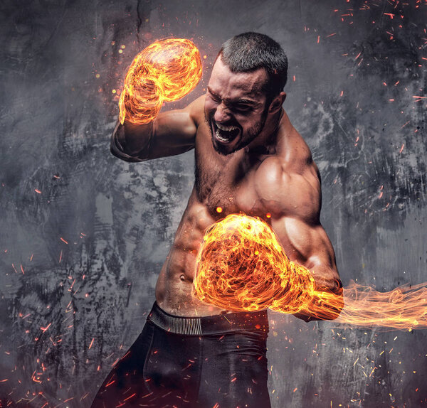 Shirtless fighter with burning boxer gloves.