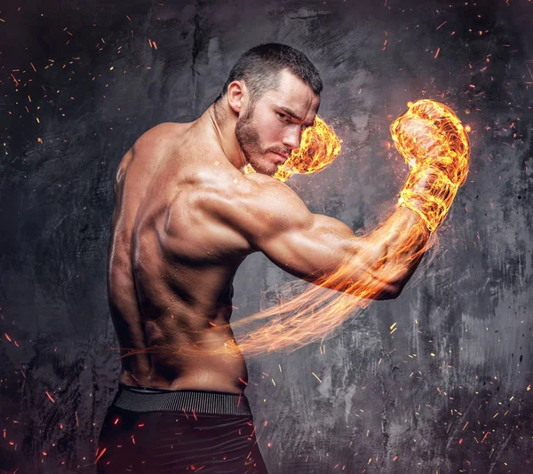 Shirtless fighter with burning boxer gloves. — Stock Photo, Image