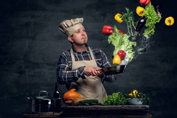 Chef with vegetables flying in the  air. — Stock Photo, Image