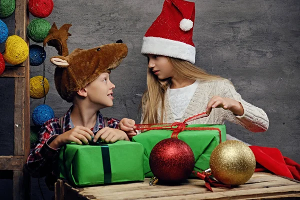 Garçon et fille posant avec des boîtes-cadeaux — Photo