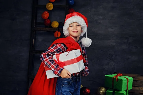 Boy holding gift box and red bag — Stock Photo, Image