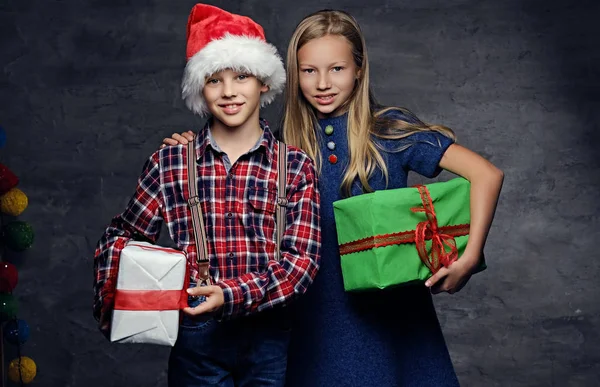 Boy in Santa's hat and blonde girl — Stock Photo, Image