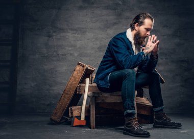 Sakallı hippi bir ahşap kutu üzerinde oturan