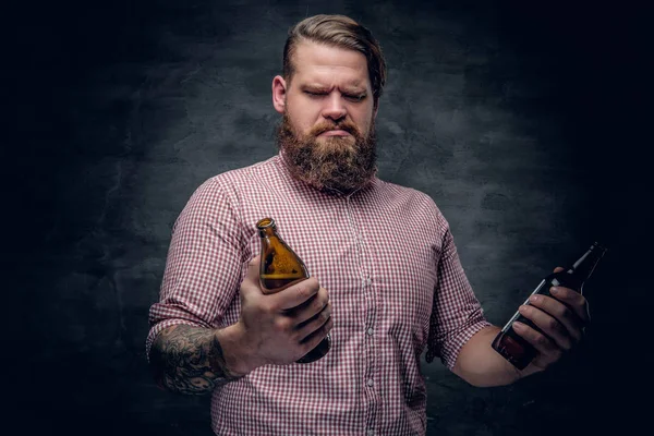 Bearded man holding beer bottles