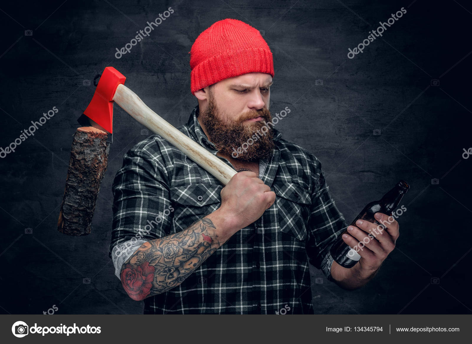 Lumberjack drinking beer from a bottle Stock Photo by ©fxquadro 134345794