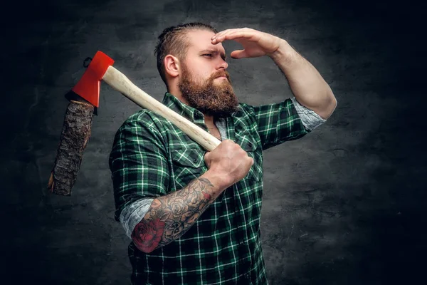 Lumberjack in a green shirt  holding axe — Stock Photo, Image