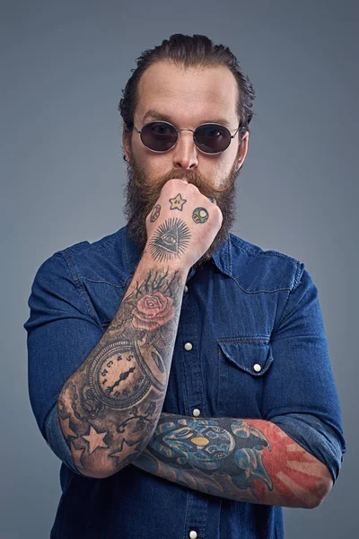 Bearded man with tattooes on arms