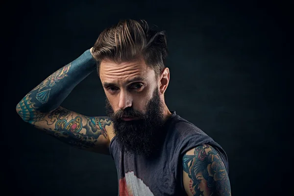 Bearded man in a t shirt touches his head — Stock Photo, Image