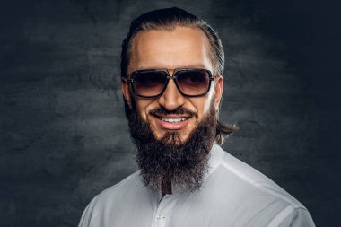 Sakallı adam beyaz bir gömlek ve güneş gözlüğü