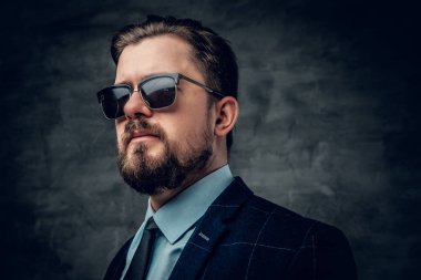 Sakallı adam bir takım elbise ve güneş gözlüğü