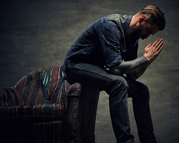 Tattooed hipster posing on a chair — Stock Photo, Image