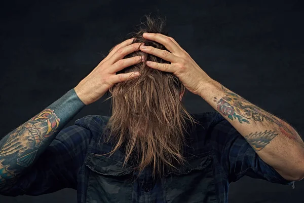 Tattooed man with long hair