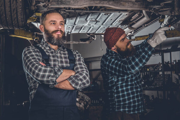 Bearded mechanics in a garage