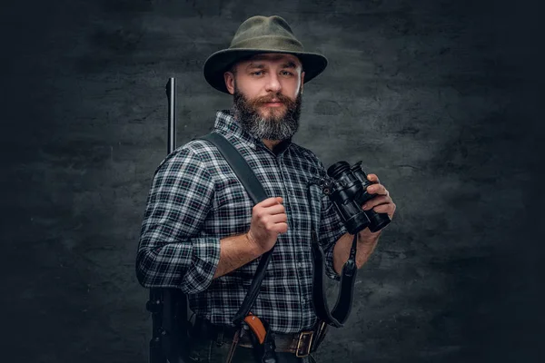 Hunter segurando uma espingarda e binóculos — Fotografia de Stock