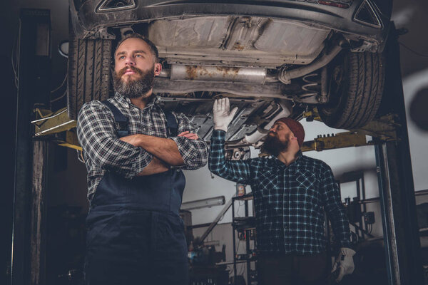 Bearded mechanics in a garage