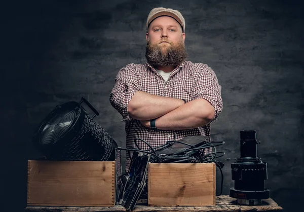 Bearded cameraman with vintage equipment