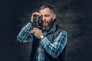 Bearded man holds video camera clipart