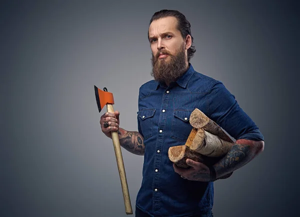 Bearded man holds ax and firewoods. — Stock Photo, Image