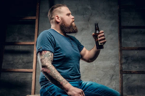 Bearded man holding beer bottle