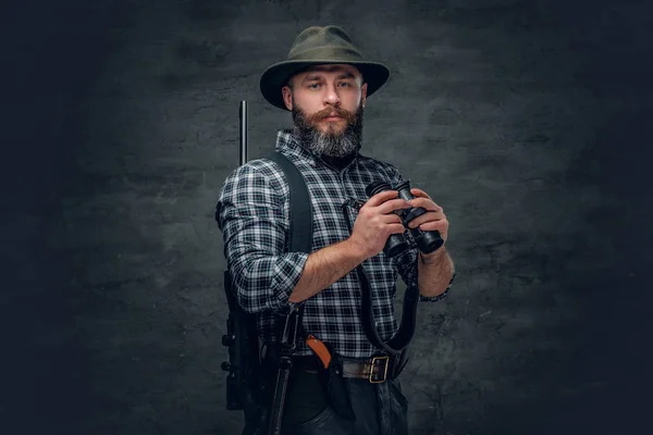 Bearded hunter holds a rifle — Stock Photo, Image