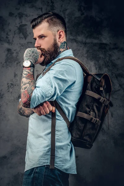 Bearded man holds urban backpack