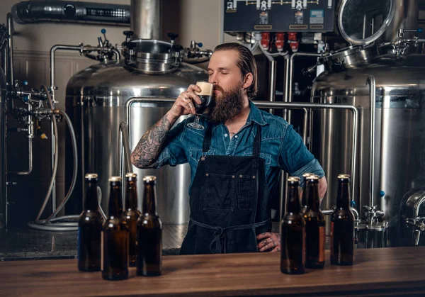 Bearded man tasting beer