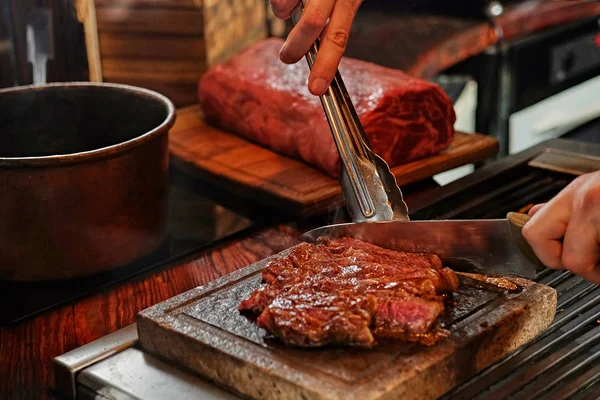 Muž vaření hovězí steak na grilu — Stock fotografie