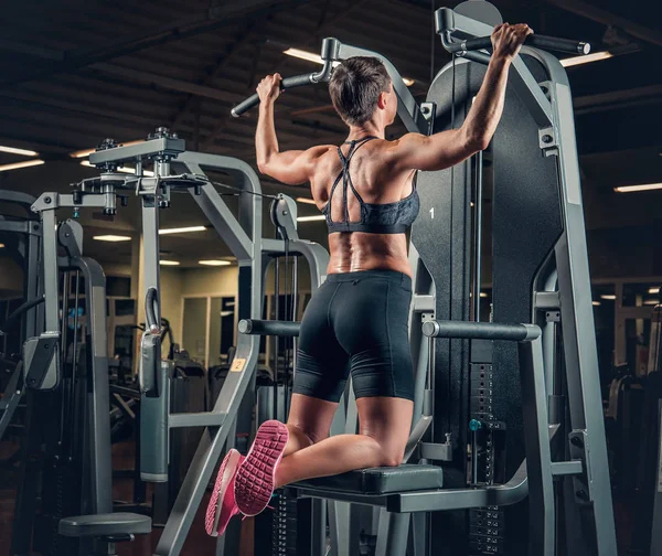 Donna con i capelli corti facendo pull up — Foto Stock