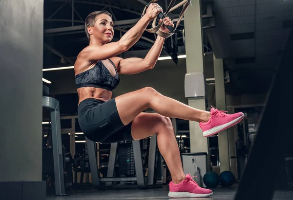 Female doing workouts with trx  strips — Stock Photo, Image