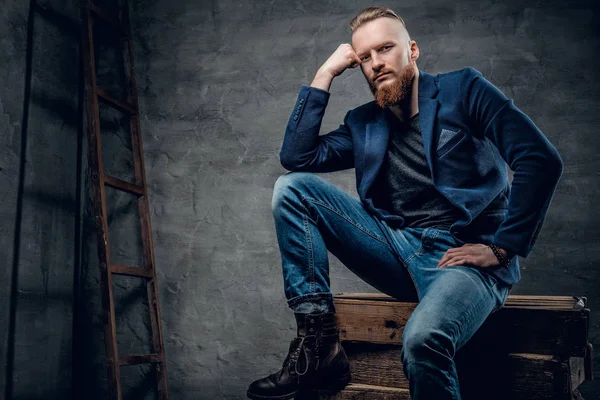 Redhead male dressed in a jeans and a jacket