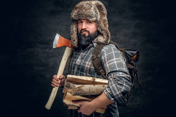 Brutal hunter male holds an ax — Stock Photo, Image