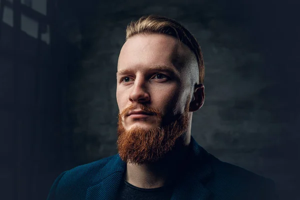 Redhead bearded hipster in a blue jacket