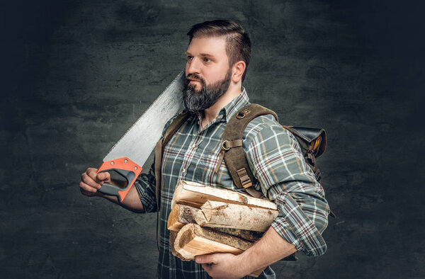 Bearded hunter holds headsaw