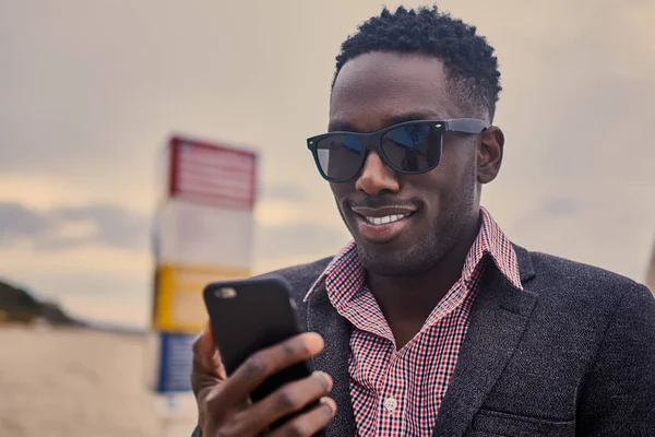 Hombre en gafas de sol usando smartphone —  Fotos de Stock