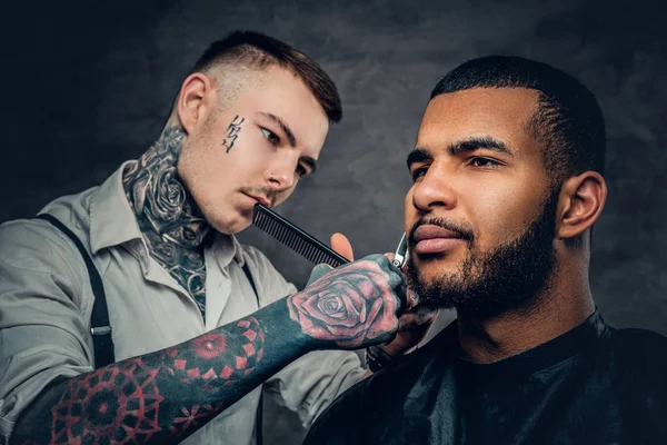 Barbier tatoué coupant la barbe — Photo