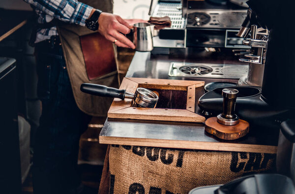 Man preparing cappuccino in a coffee machine