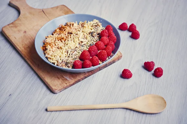 Raspberries, nuts and sunflower seeds in a cup — Stock Photo, Image