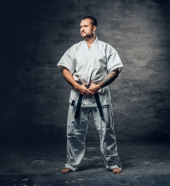 Karate fighter dressed in a white kimono — Stock Photo, Image