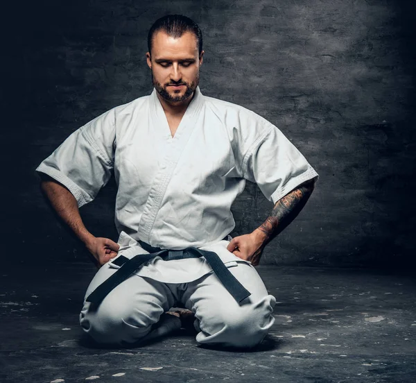 Karate fighter dressed in a white kimono — Stock Photo, Image