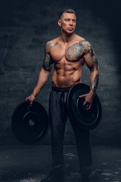 Shirtless male holds barbell weights — Stock Photo, Image
