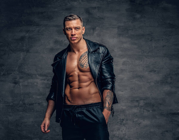 Stylish muscular male in leather jacket 