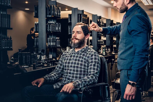 Stylish male hairdresser doing haircut — Stock Photo, Image
