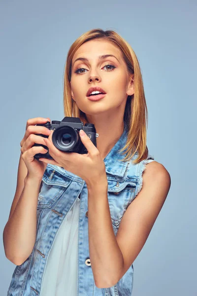 Female holds digital photo camera