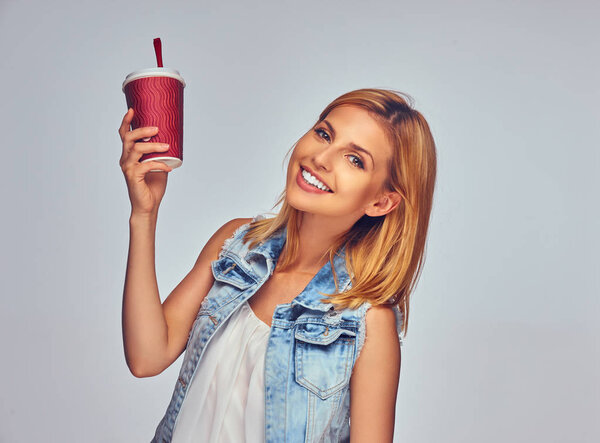 Позитивная женщина держит бумажную красную чашку
