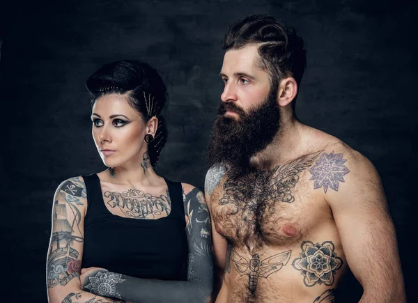 Studio portrait of tattooed couple